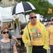 Cindy Miller walks with her husband Phil, both of Arizona, as he carries a tiny golf umbrella while it sprinkles on Main St during the Summer Art Fair on Wednesday. Melanie Maxwell I AnnArbor.com